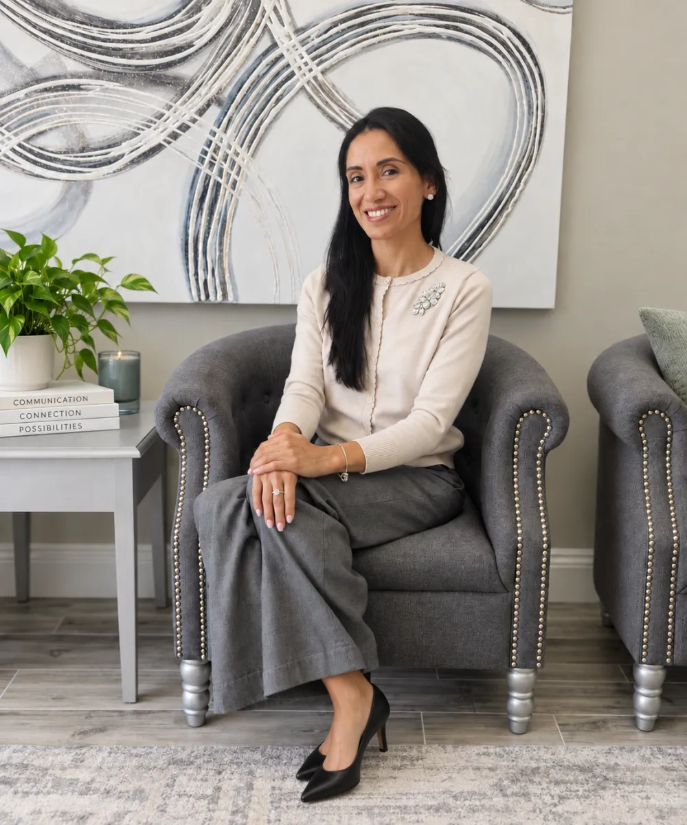 Karin Cardozo, M.S., CCC-SLP, seated in her Tampa office